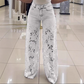 Jeans i patchwork-design med blonder